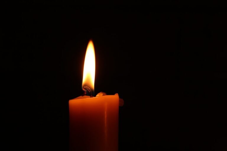 A lit candle representing a memorial tribute to Carla Jeffery