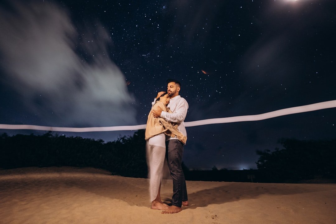 Couple stargazing together under the night sky